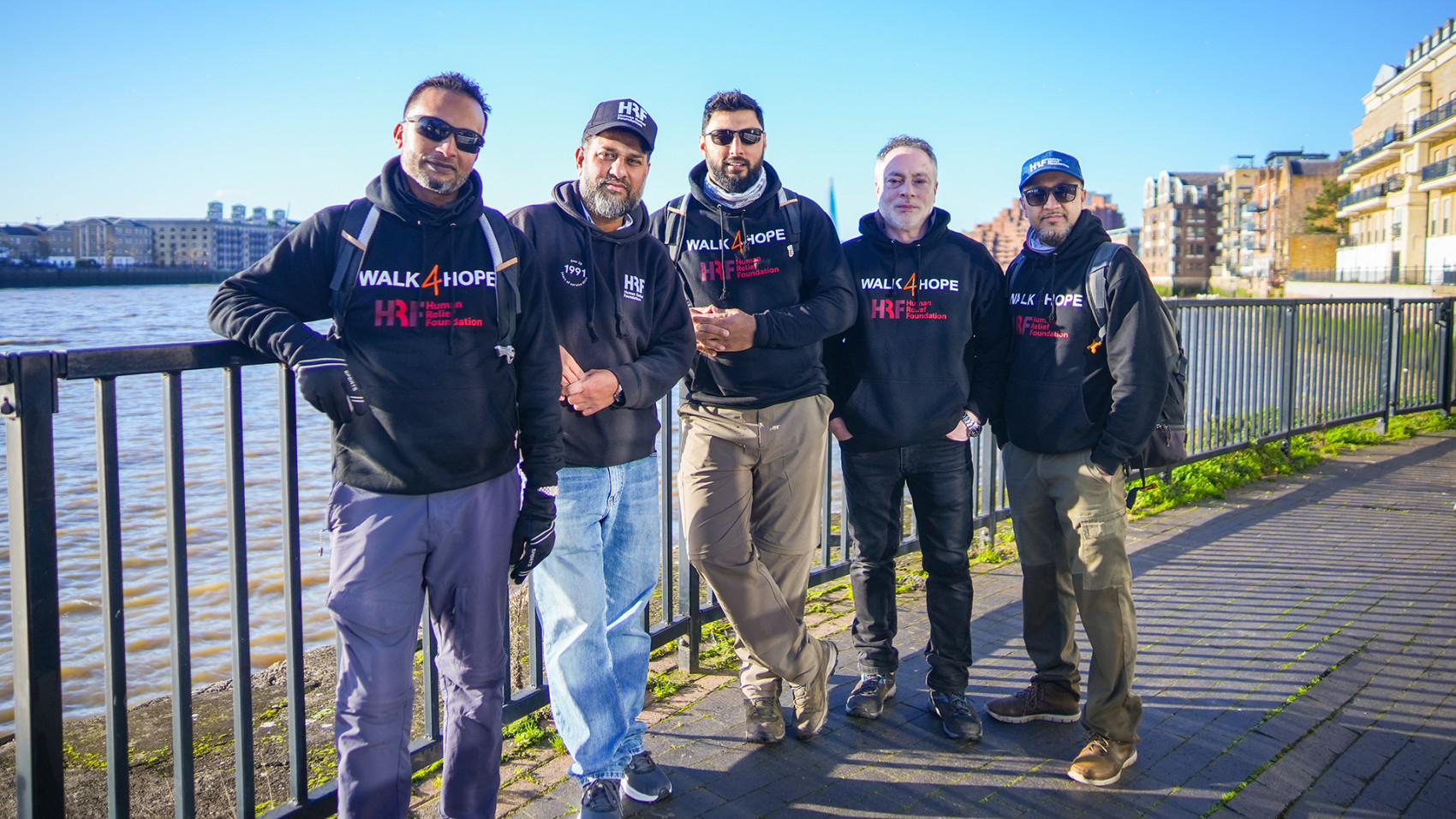 Four walkers posing for a waterfront photo call 