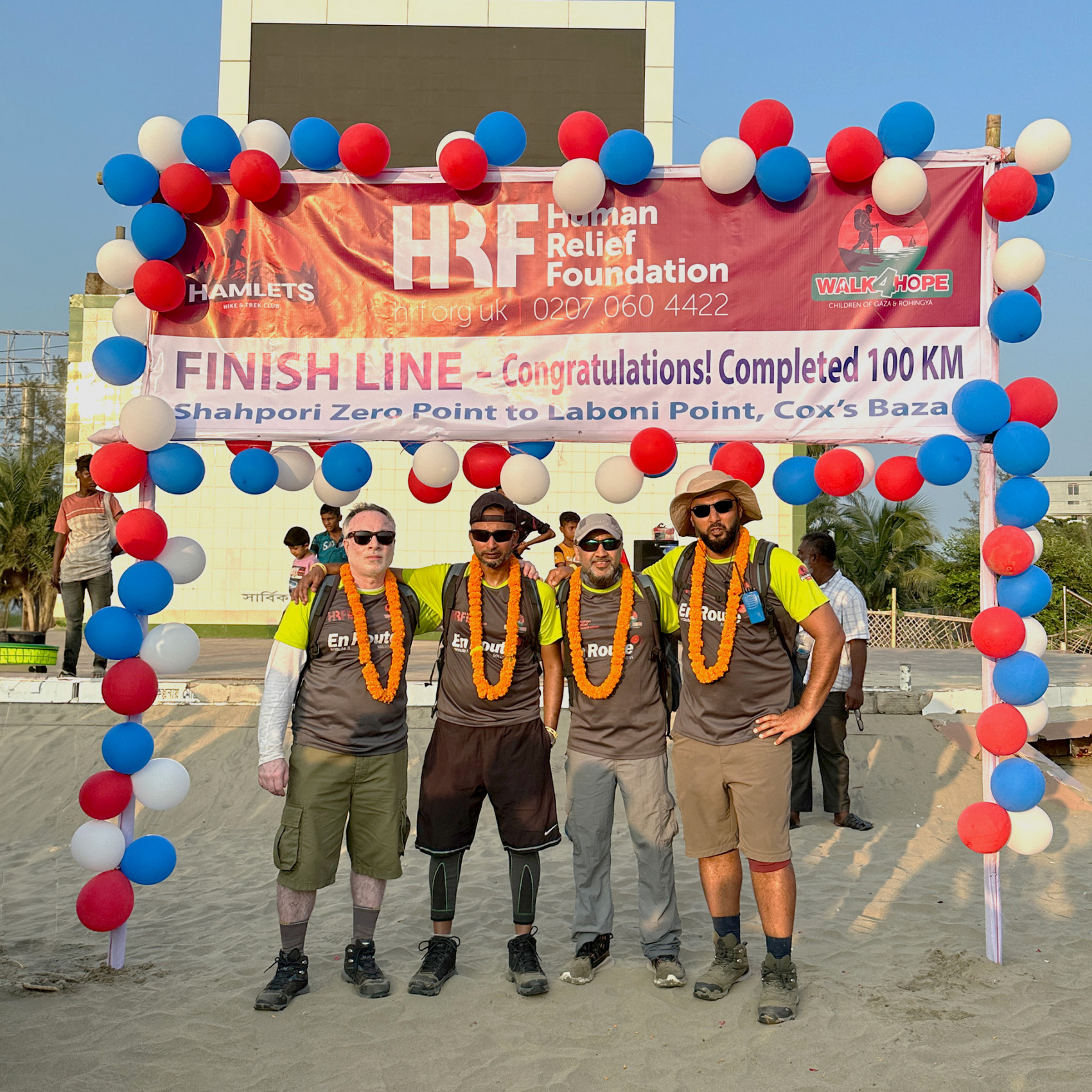 Four walkers posing for a waterfront photo call 