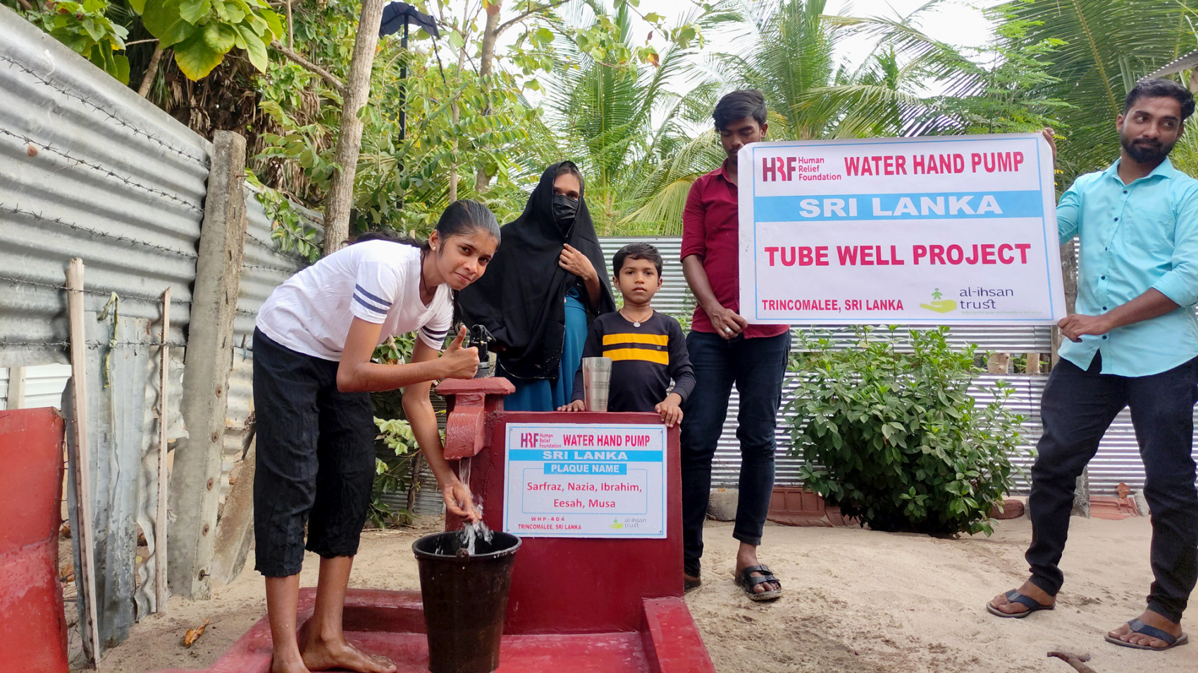 A newly installed tube well in Sri Lanka with a Sri Lankan family in attendance..