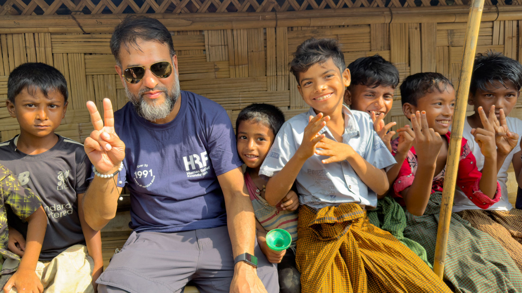 HRF staff with Rohingya children at a refugee camp in Cox&#039;s Bazar, Bangladesh